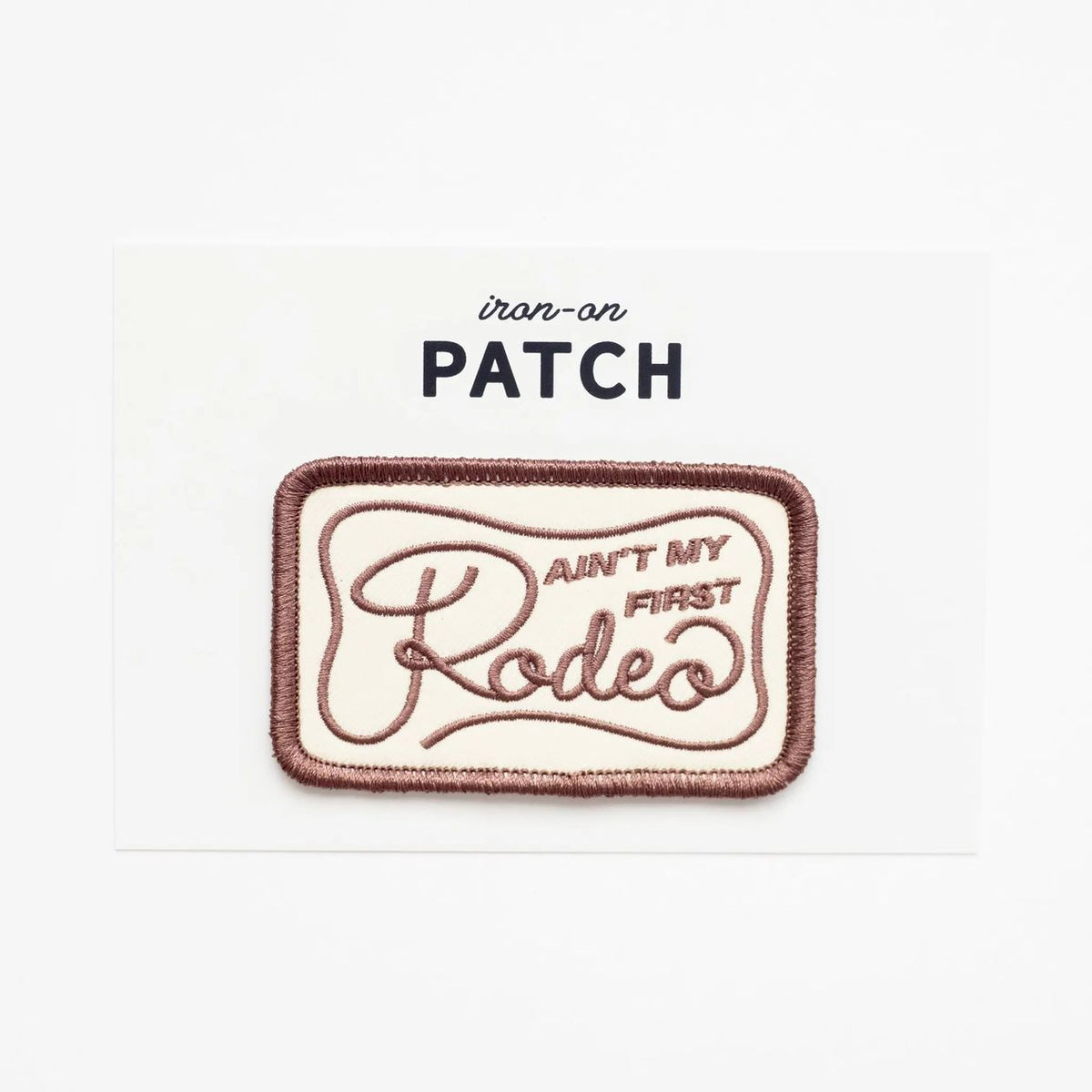 Iron-on patch with text 'Ain't my first rodeo' on a white background