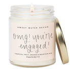 Candle in a jar with 'Sweet Water Decor' branding and text on a white background