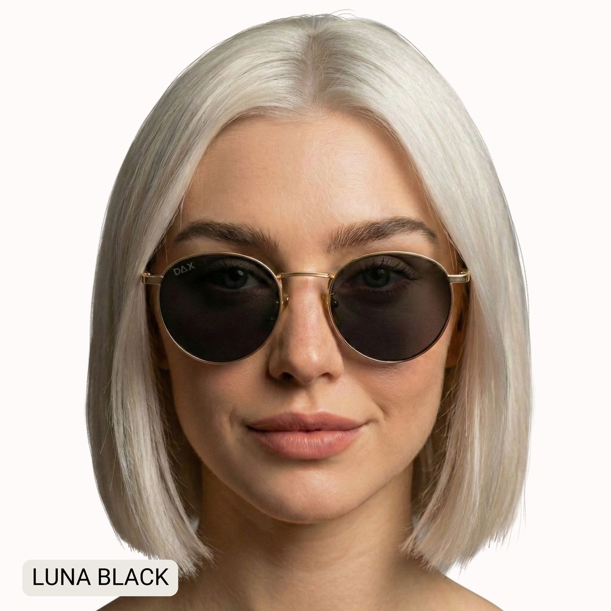 A woman with a platinum blonde bob wears round sunglasses with dark lenses and thin gold metal frames. The text 'LUNA BLACK' appears in the bottom-left corner.