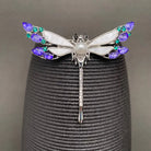 Close-up of rhinestone dragonfly brooch showing gemstone wing detail