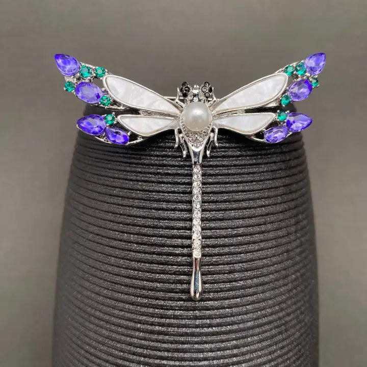 Close-up of rhinestone dragonfly brooch showing gemstone wing detail