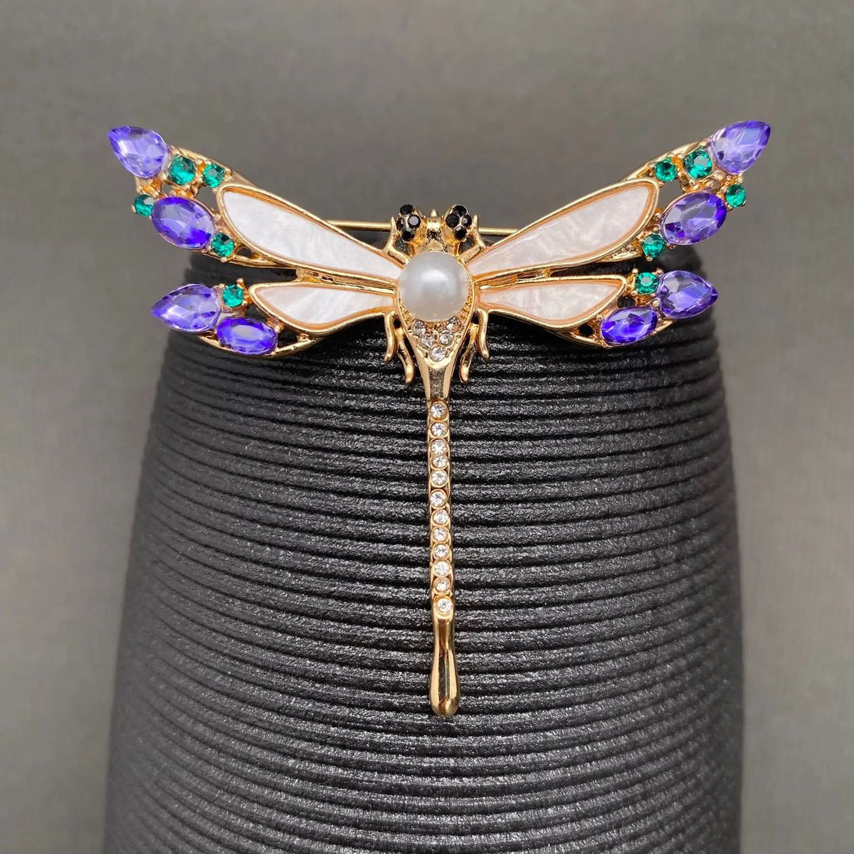 Rhinestone dragonfly brooch with gold-tone body and multicolor gem wings