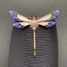 Rhinestone dragonfly brooch with gold-tone body and multicolor gem wings
