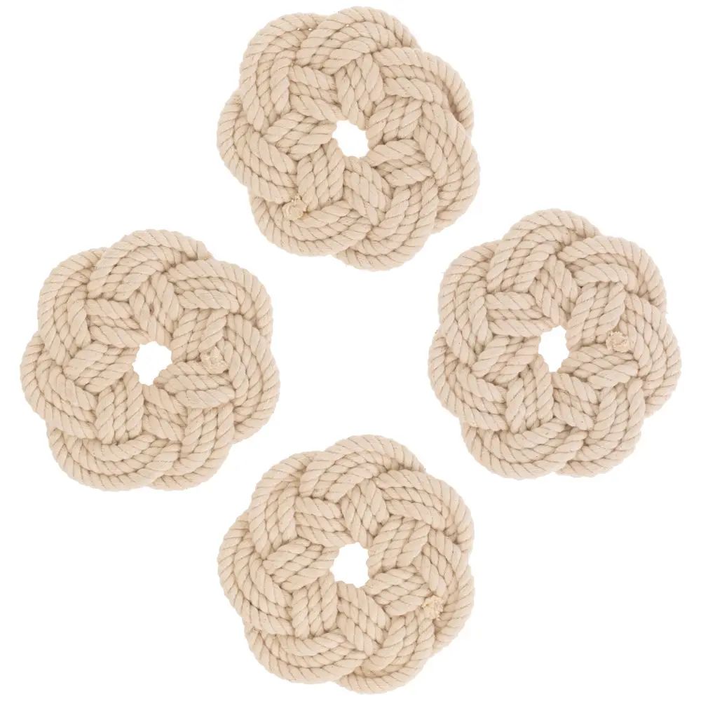 Four natural beige braided rope flower-shaped dog toys arranged on a plain white background.