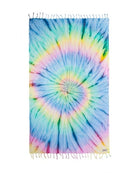 A rectangular tie-dye towel with a spiral rainbow pattern and fringed edges, shown flat against a white background.