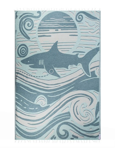Shark-themed towel with wave patterns on a white background