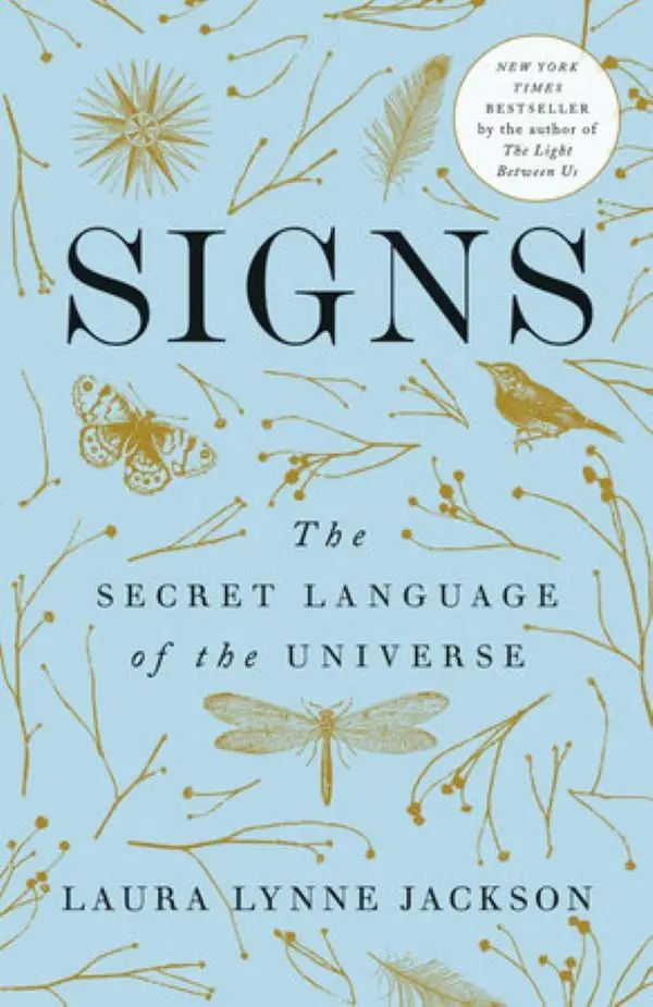 Book cover of 'SIGNS: The Secret Language of the Universe' by Laura Lynne Jackson with decorative elements on a light blue background.