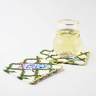 Snowman shaped gold-rimmed glass of white wine on embroidered holiday cocktail napkins