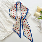 Silk scarf with strawberry pattern on a white surface