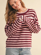 Full-length view of the &merci Striped Pocket Sweater in wine and pink styled with light-wash jeans