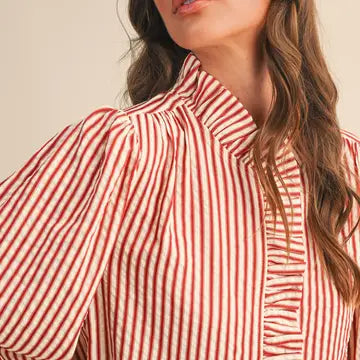 Close-up of the &merci Striped Ruffle Blouse showing the ruffled high neckline and ruffle-trimmed button placket