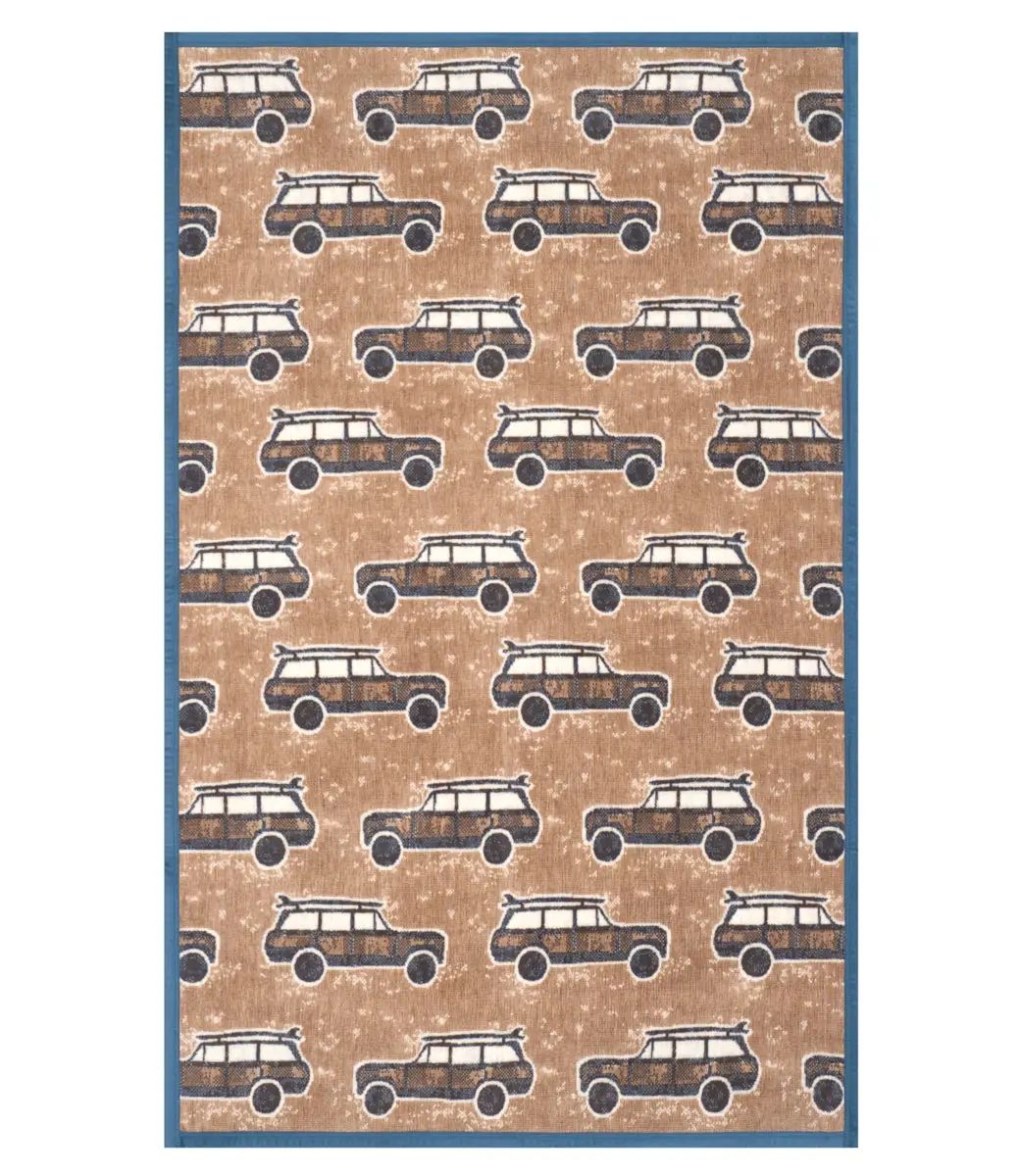 A rectangular rug with a repeating pattern of vintage station wagons on a tan background, finished with a solid blue border.