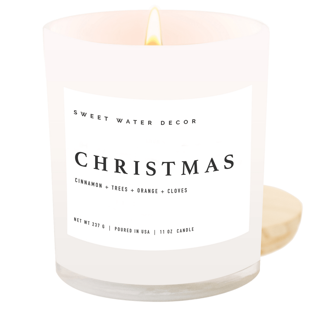 Sweet Water Decor Christmas 11 oz soy candle in a white jar with wood lid