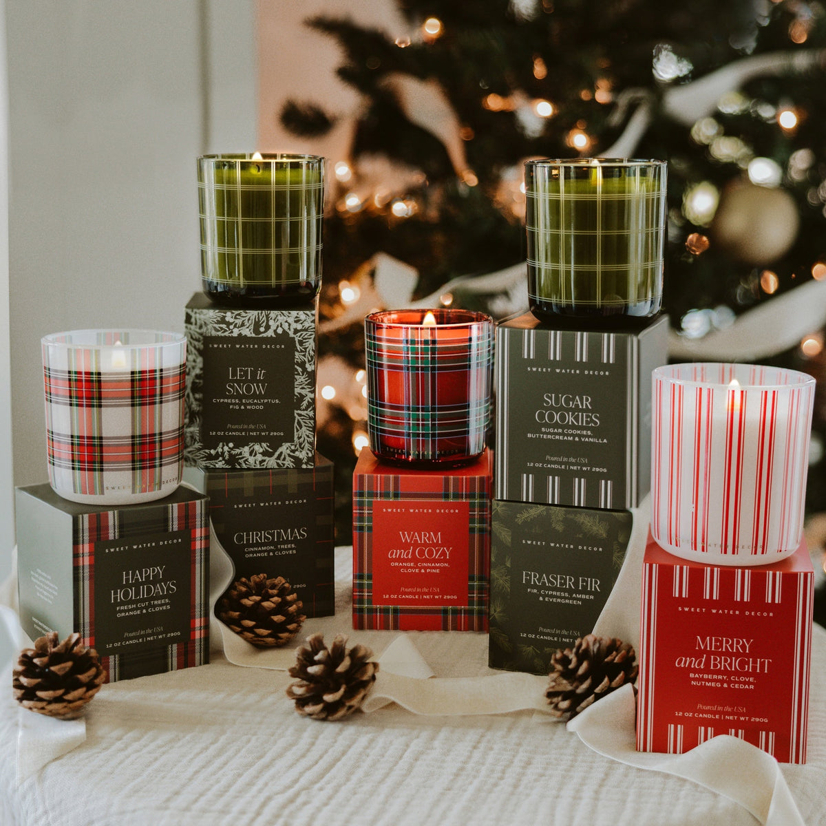 Sweet Water Decor boxed Christmas candles including Warm and Cozy under a tree