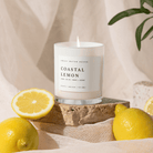 Coastal Lemon soy candle styled with fresh lemons and greenery