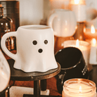 Ghost coffee mug styled with candles for cozy fall decor