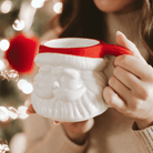 Red Hat Santa figurine coffee mug styled with Christmas lights