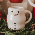 Sweet Water Decor Snowman figurine coffee mug styled with evergreen and holiday lights