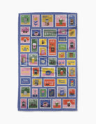 Tea towel with colorful coffee-themed postage stamp designs on a blue background