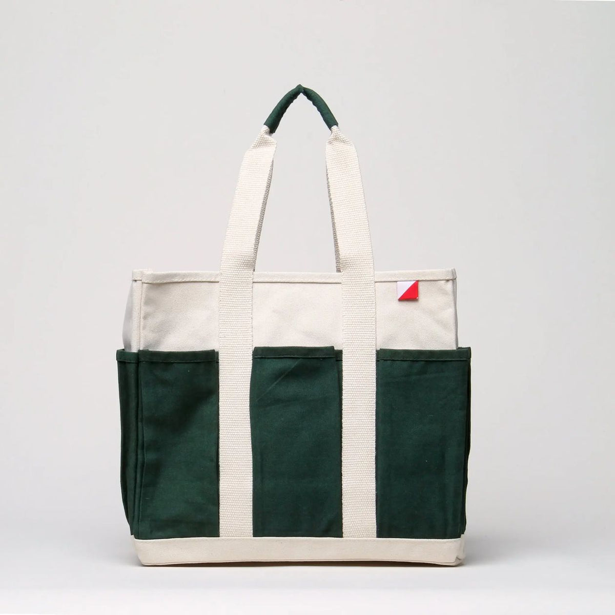 Tote bag with green and white sections on a light gray background