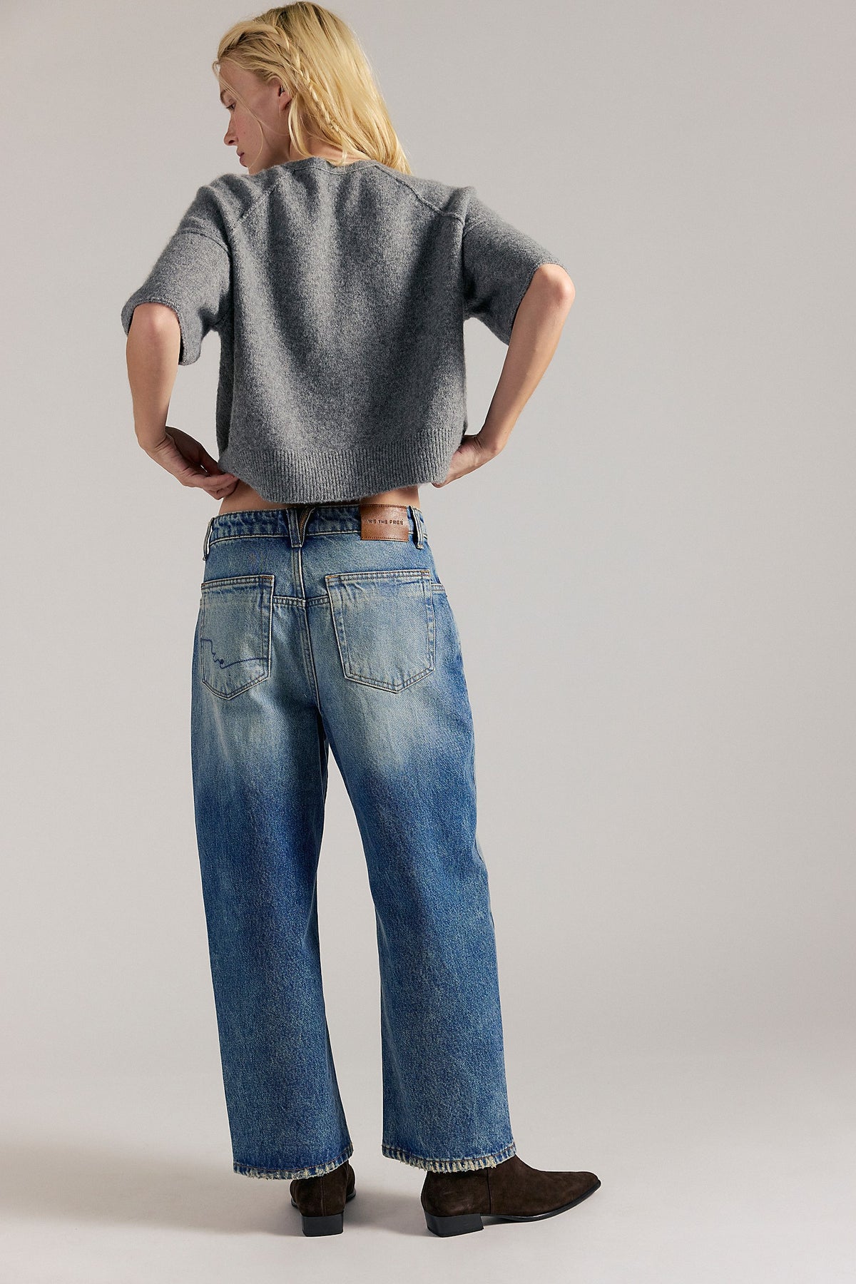 Back view of We The Free Deep Trance Dropped Boyfriend Jeans in From Beyond medium wash with a grey knit top