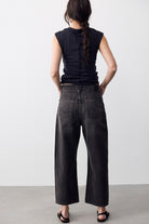 Back view of We The Free Deep Trance Dropped Boyfriend Jeans in Hypnosis washed black with a black tee