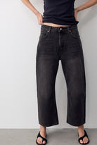 Model wearing We The Free Deep Trance Dropped Boyfriend Jeans in Hypnosis washed black, front view