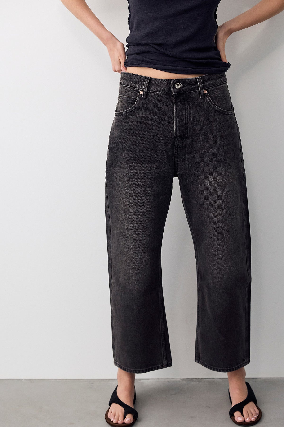 Model wearing We The Free Deep Trance Dropped Boyfriend Jeans in Hypnosis washed black, front view