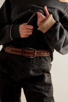 We The Free Sola Stud Belt in cognac leather worn with a black top and jeans