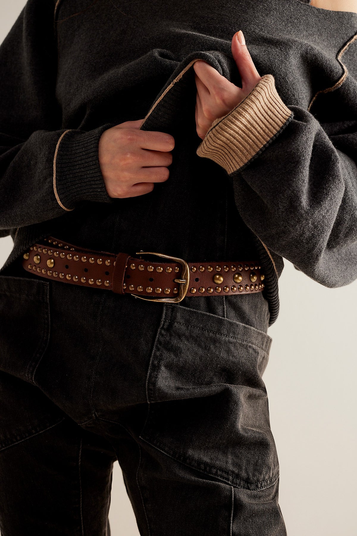 We The Free Sola Stud Belt in cognac leather worn with a black top and jeans