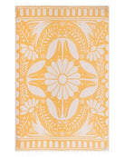 Yellow towel with white floral pattern on a white background